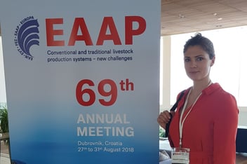 Eine Frau im roten Oberteil steht lächelnd neben einem großen Roll-up zum 69. Annual Meeting der EAAP (European Federation of Animal Science) in Dubrovnik.